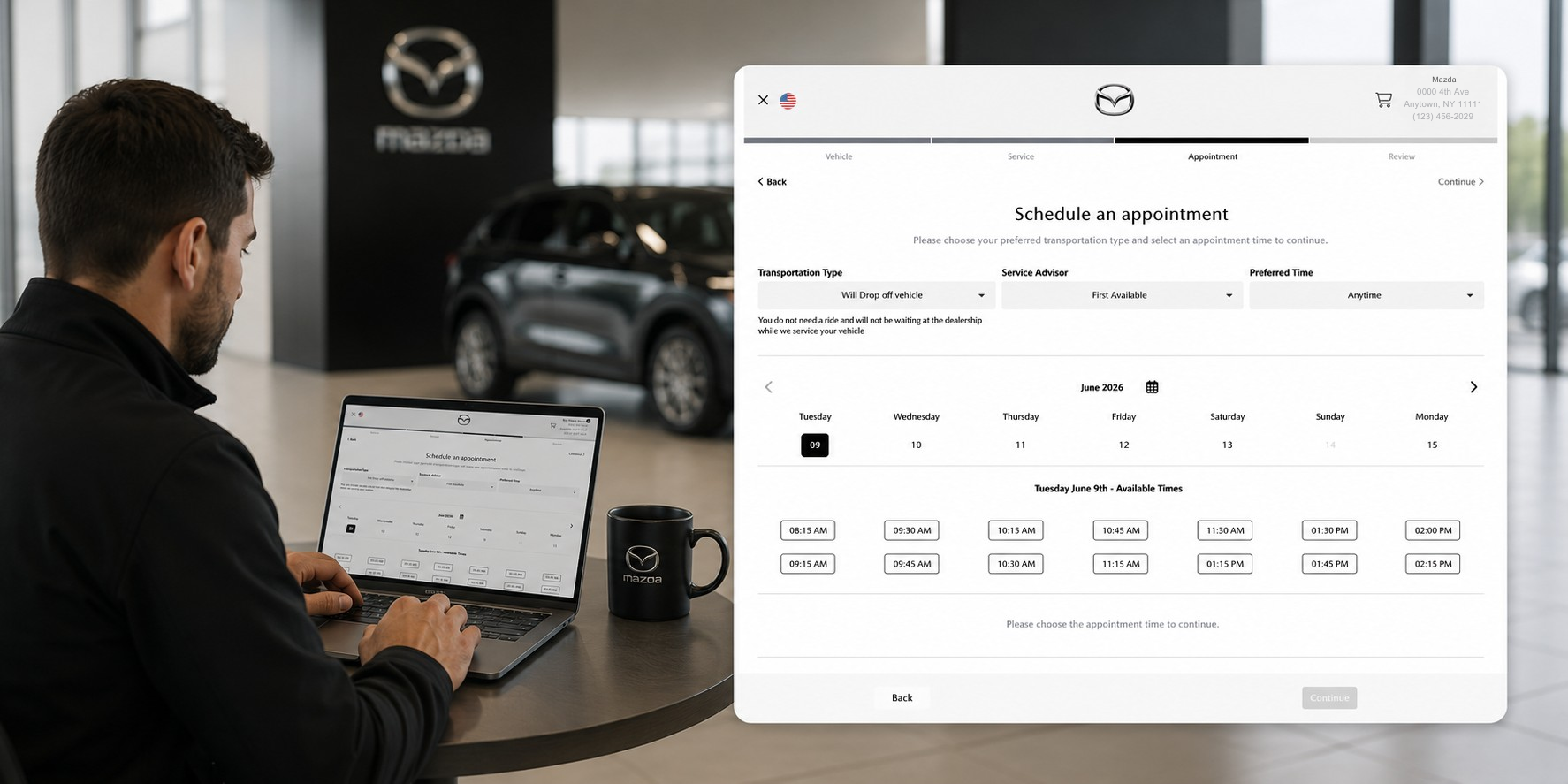 Man in a Mazda showroom sits at a table using a laptop, with a large appointment-scheduling form visible on screen and a Mazda mug nearby.